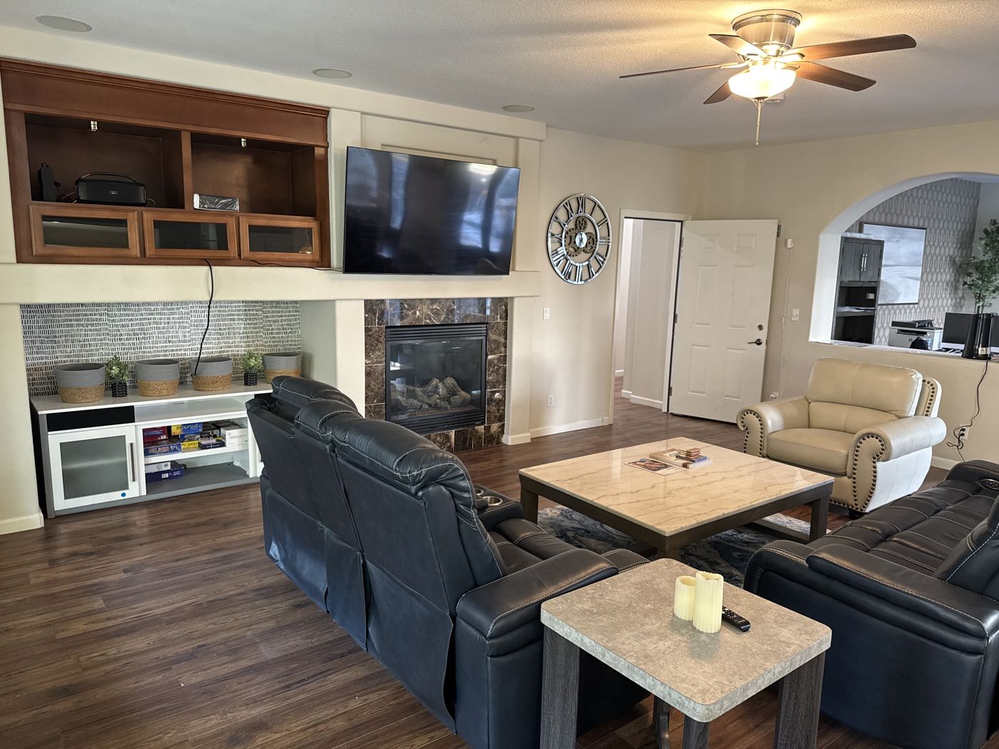 Lounge area with a shelf of board games and comfortable recliners.